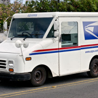 Passing mail truck injures construction worker